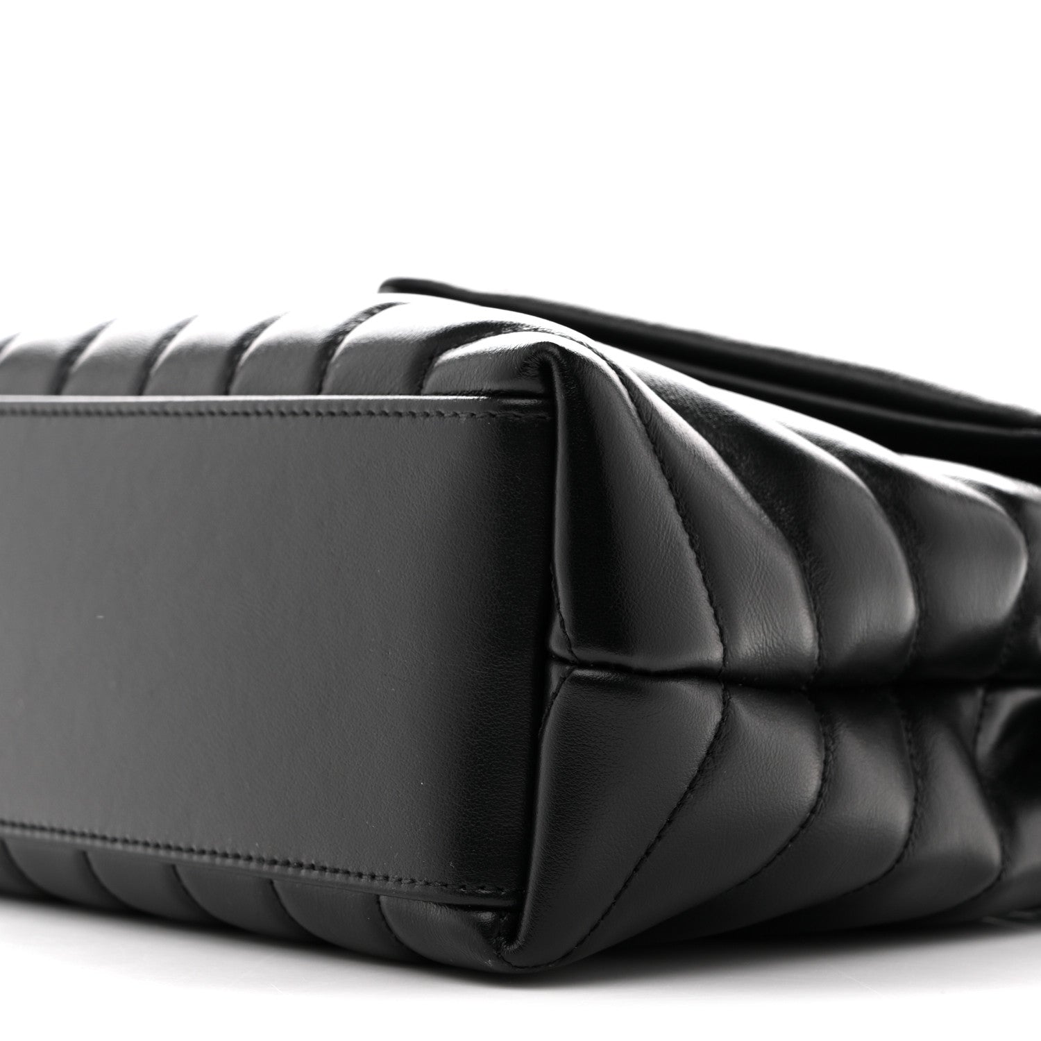 Black quilted satchel corner with chain strap and top edge seam