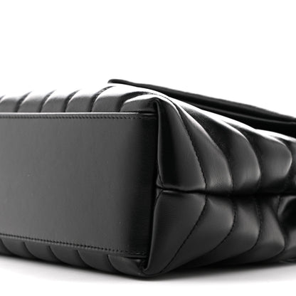 Black quilted satchel corner with chain strap and top edge seam