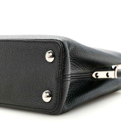 Louis Vuitton Capucines BB black leather corner with round studs and metal trim