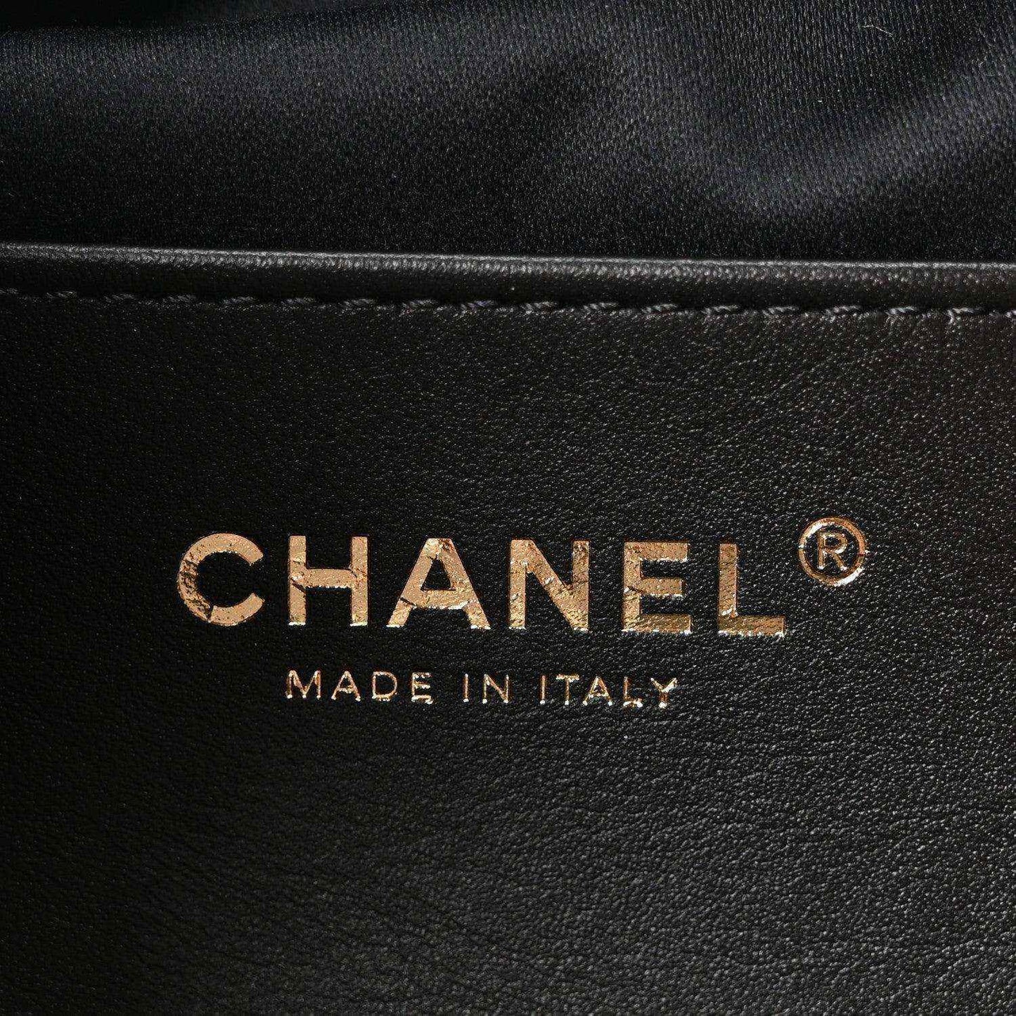 Chanel logo on black leather mini handbag with "MADE IN ITALY" text