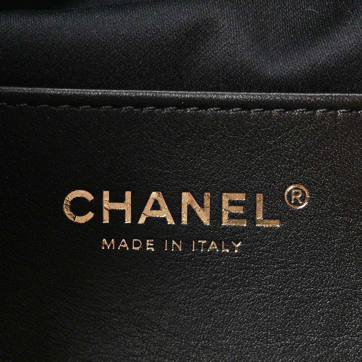 Chanel logo on black leather mini handbag with "MADE IN ITALY" text