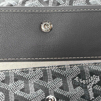 Front flap snap button and stitched trim on grey coated canvas hobo bag