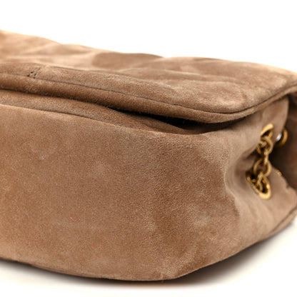 Taupe suede mini shoulder bag close-up with gold chain and side flap