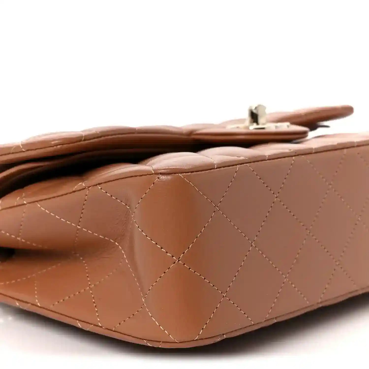 Side close-up of quilted brown leather flap shoulder bag with top clasp hardware.