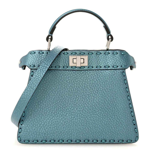 Blue pebbled leather petite satchel with top handle, clasp, and shoulder strap.