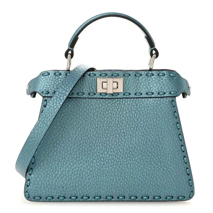 Blue pebbled leather petite satchel with top handle, clasp, and shoulder strap.