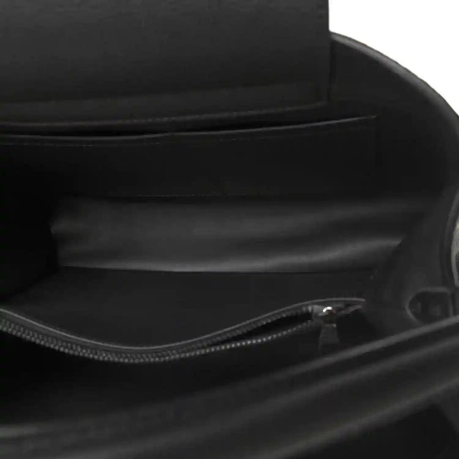 Black leather handbag interior with zip closure and fabric lining