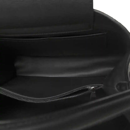 Black leather handbag interior with zip closure and fabric lining