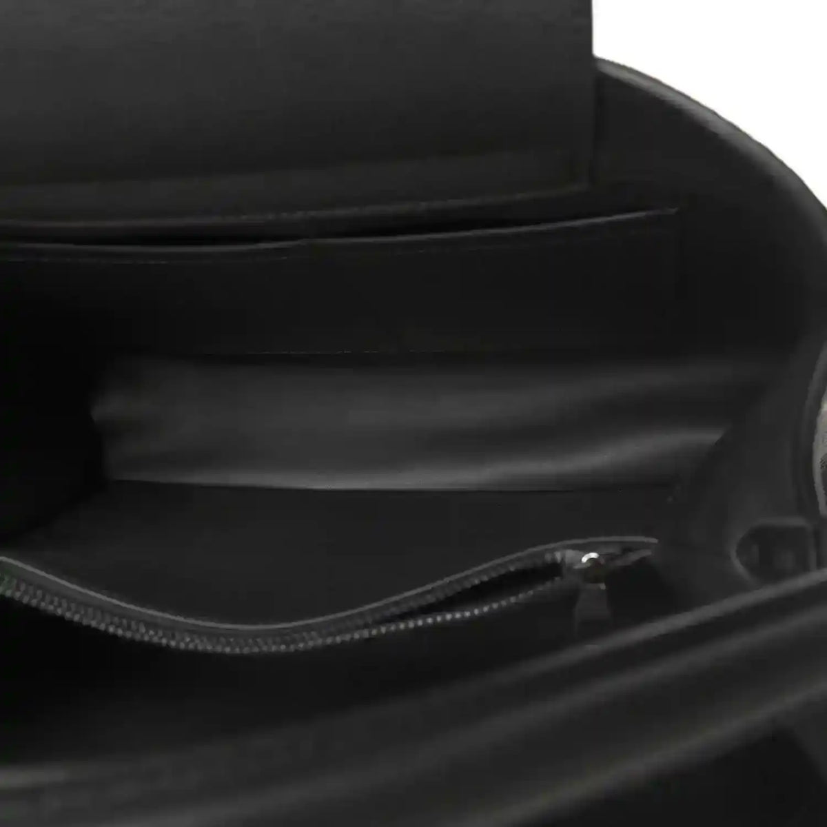 Black leather handbag interior with zip closure and fabric lining