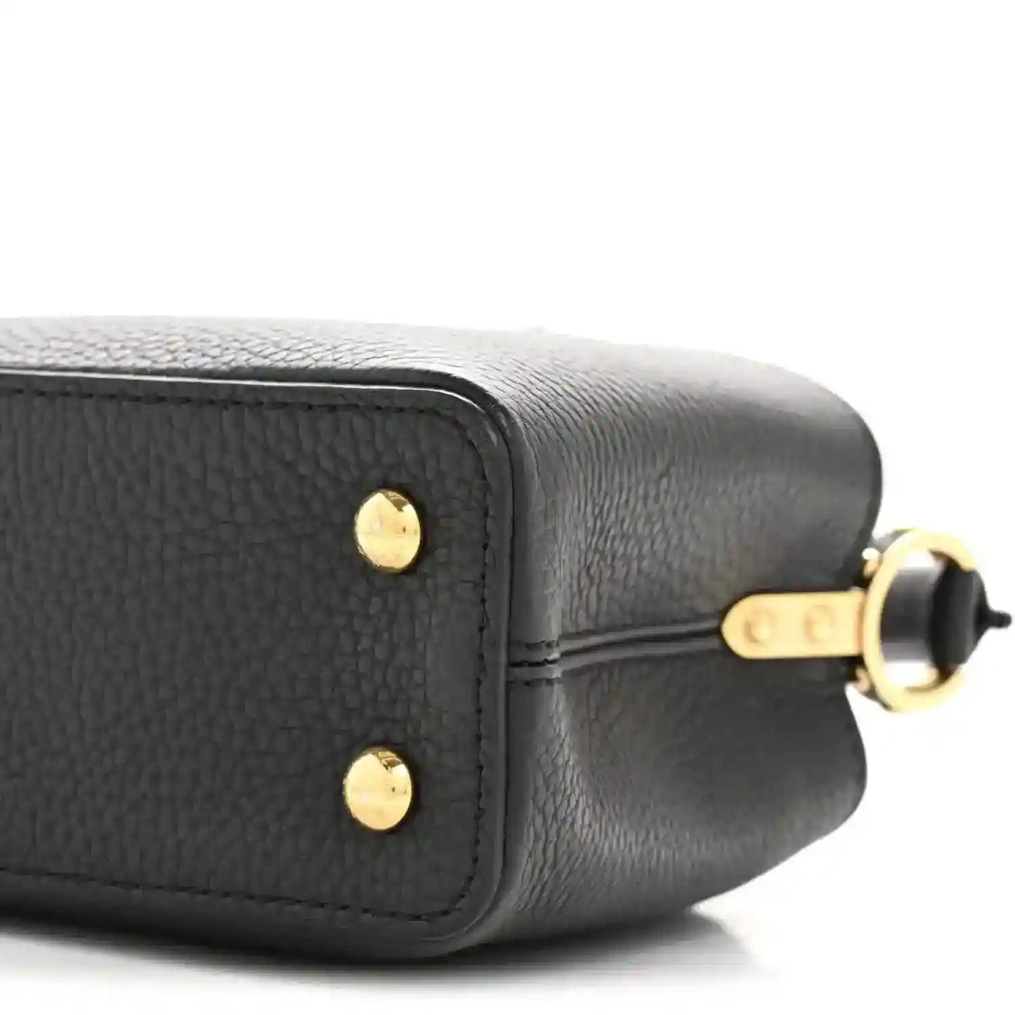Black textured leather mini bag corner with gold-tone stud detail and strap hardware