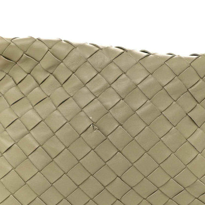 Close-up of woven lambskin leather texture on hobo bag exterior, travertine