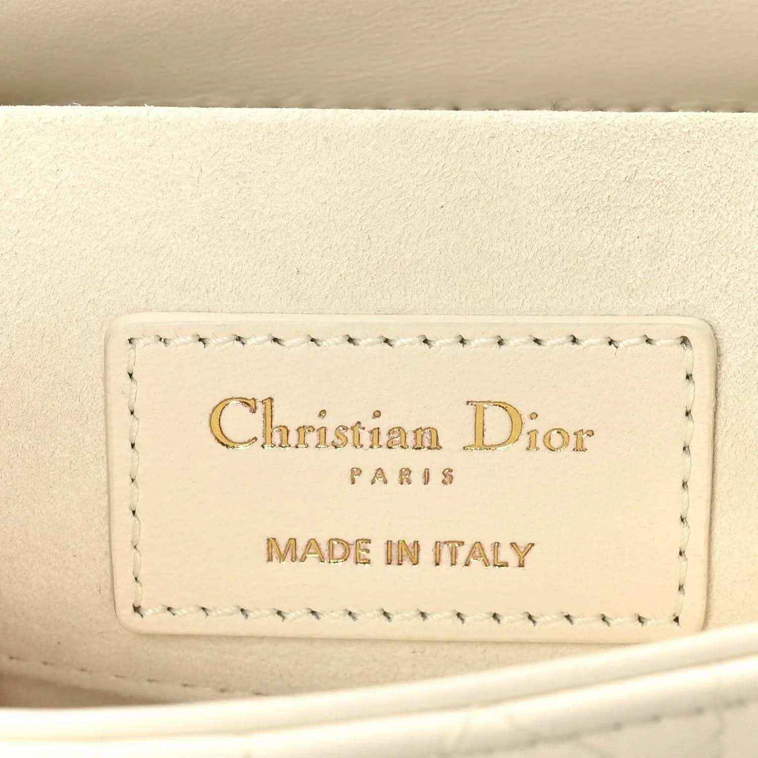 White handbag interior label reading Christian Dior Paris and Made in Italy