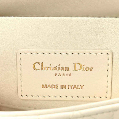 White handbag interior label reading Christian Dior Paris and Made in Italy