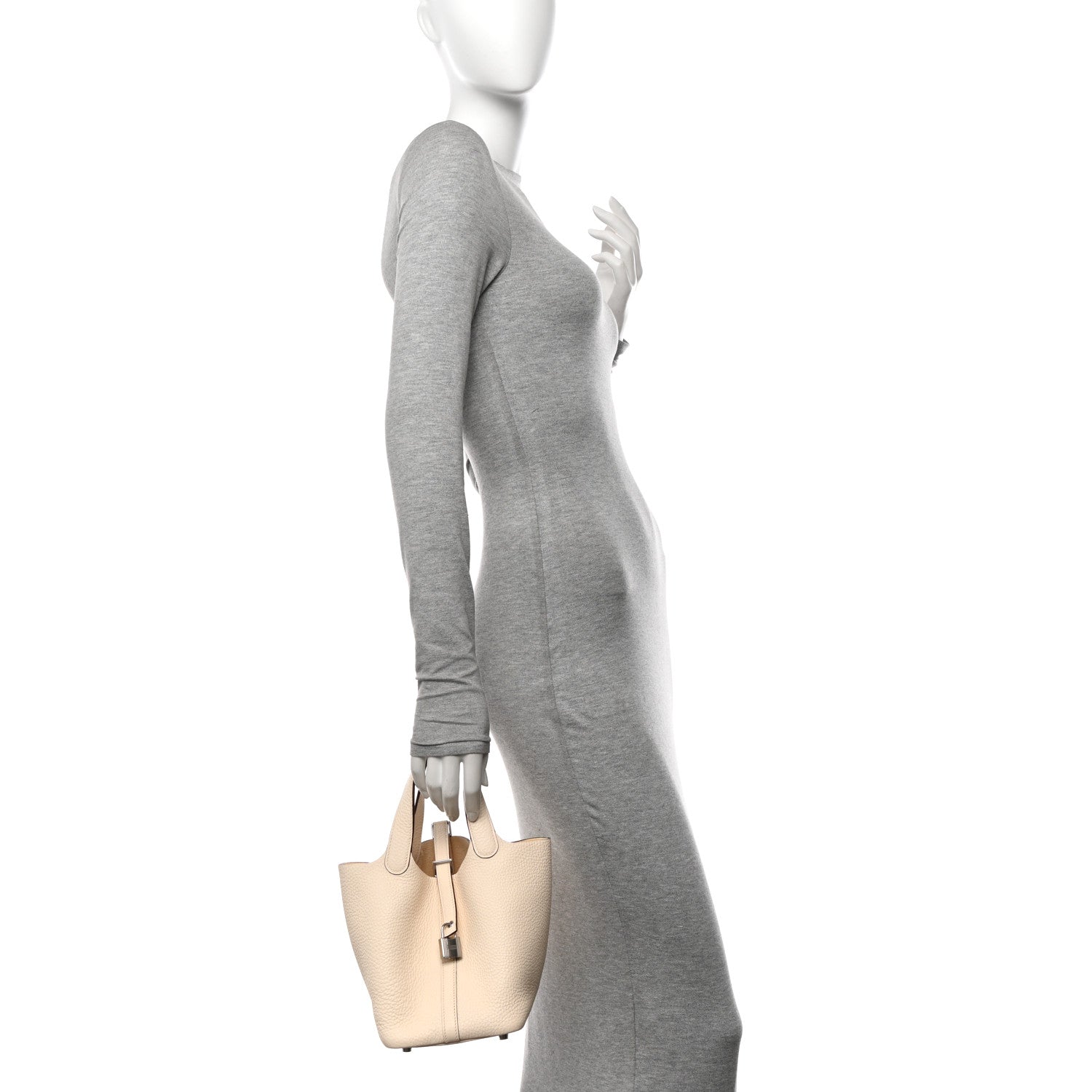 Nata leather handbag carried by a model with short top handles and lock closure