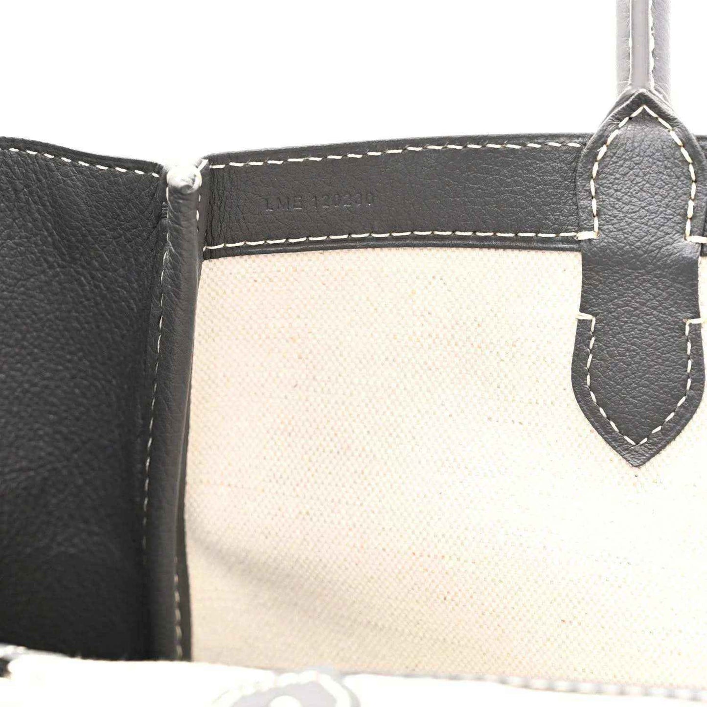 Tote interior with stitched pocket edges and leather trim, open top view