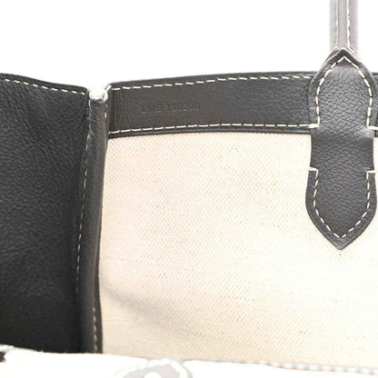 Tote interior with stitched pocket edges and leather trim, open top view