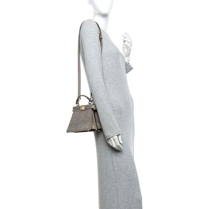 Gray woven raffia satchel with adjustable crossbody strap and gold hardware