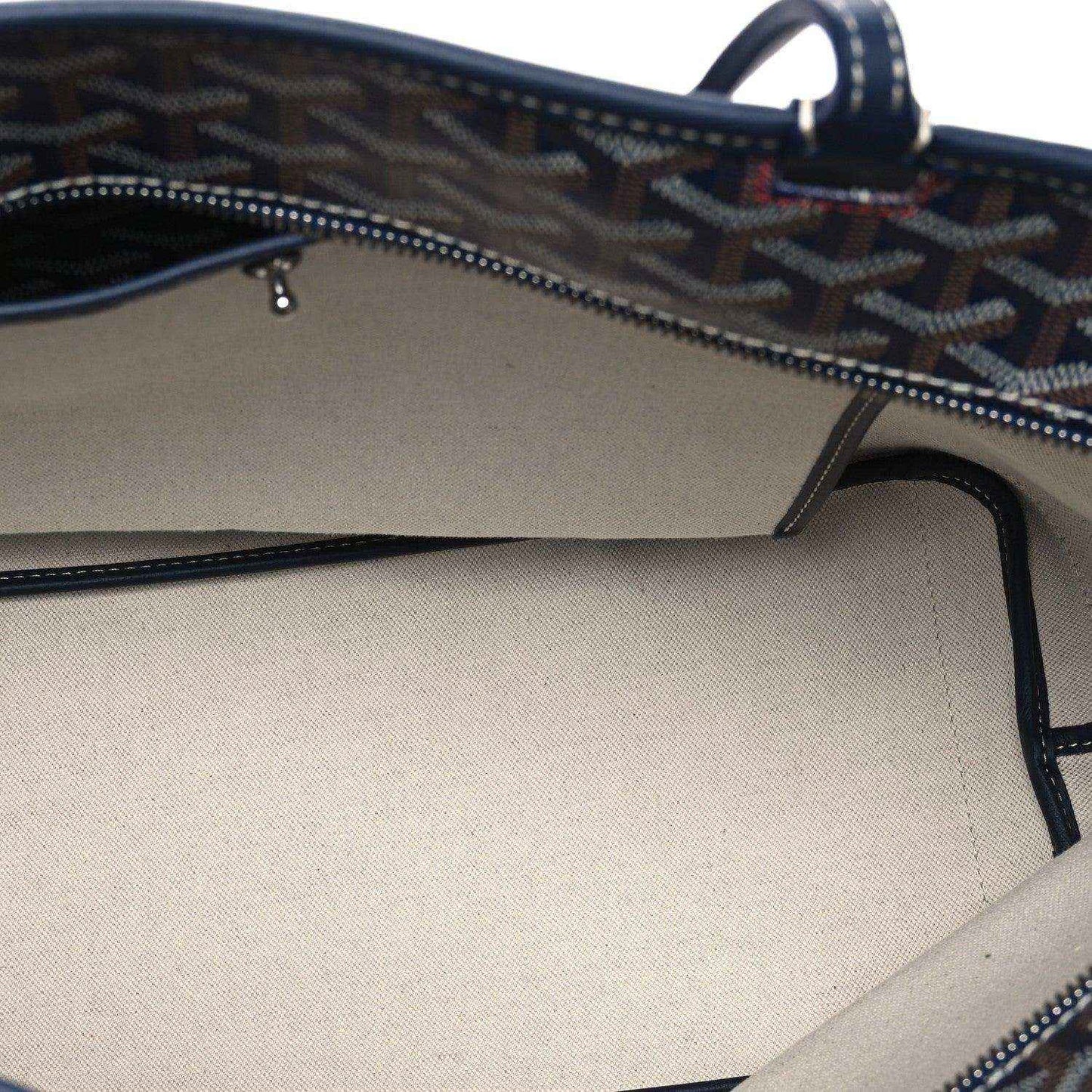Navy tote bag interior showing zipper track and stitched top opening