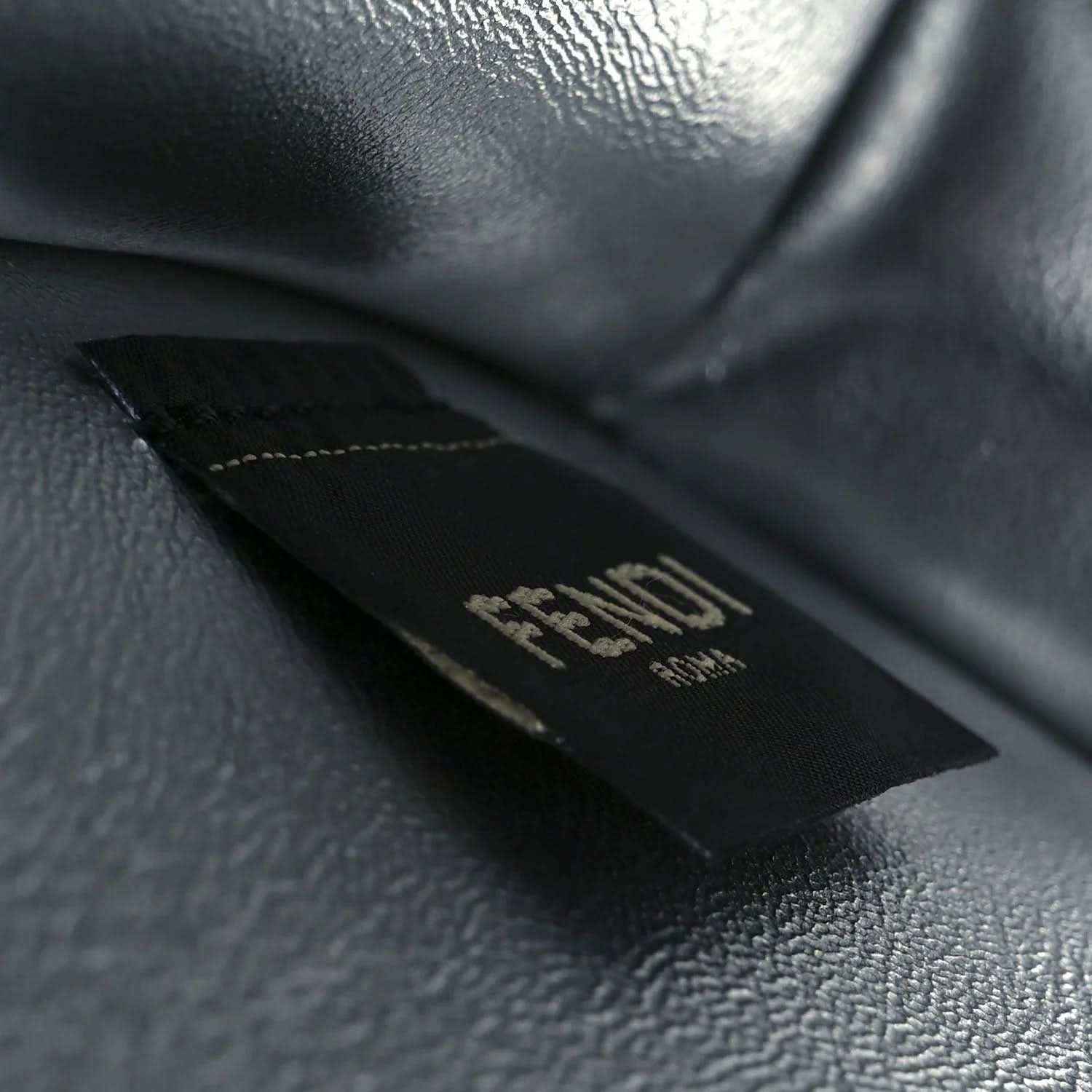 Fendi logo patch on dark leather interior lining of the satchel