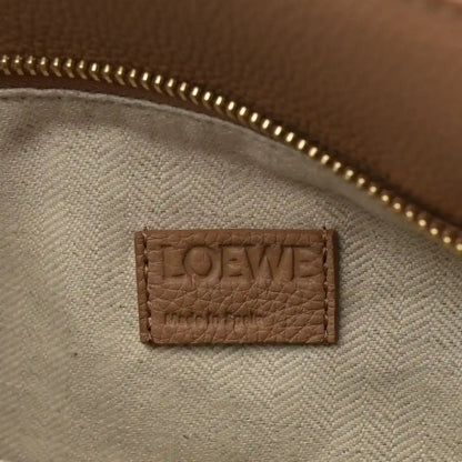 Loewe leather label on bag interior lining with gold zipper trim