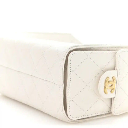 White quilted mini handbag corner close-up with CC turn-lock hardware
