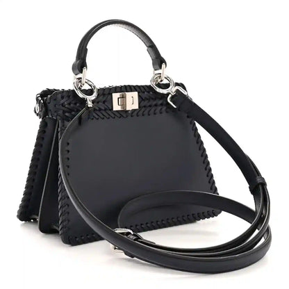 Midnight blue leather petite satchel with woven texture, ring handles and crossbody strap