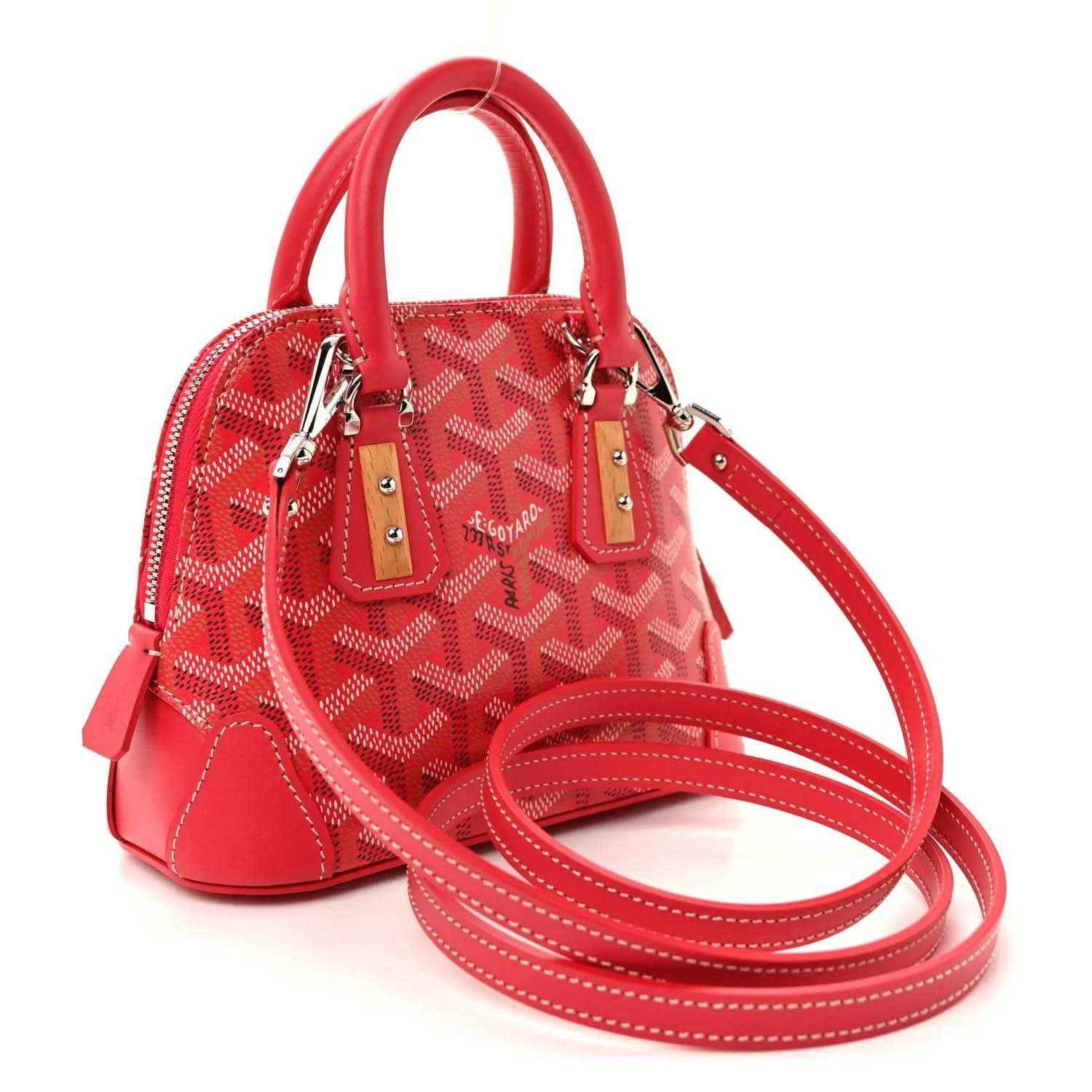 Fuchsia mini handbag with patterned body, red crossbody strap, and silver hardware