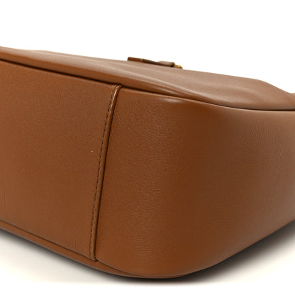 Saint Laurent hobo bag close-up of smooth brown leather top edge and side seam