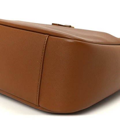 Saint Laurent hobo bag close-up of smooth brown leather top edge and side seam