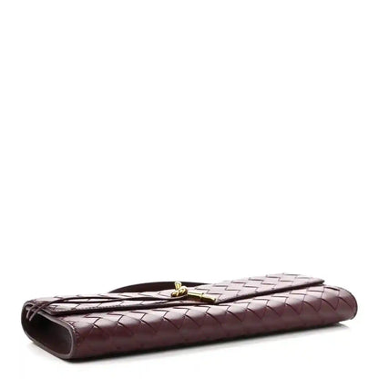 Bottega Veneta burgundy nappa clutch with woven pattern and curved top closure