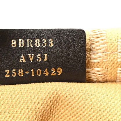 Fendi jacquard raffia fringe bag, close-up of dark leather stamp with “AV5J” and digits