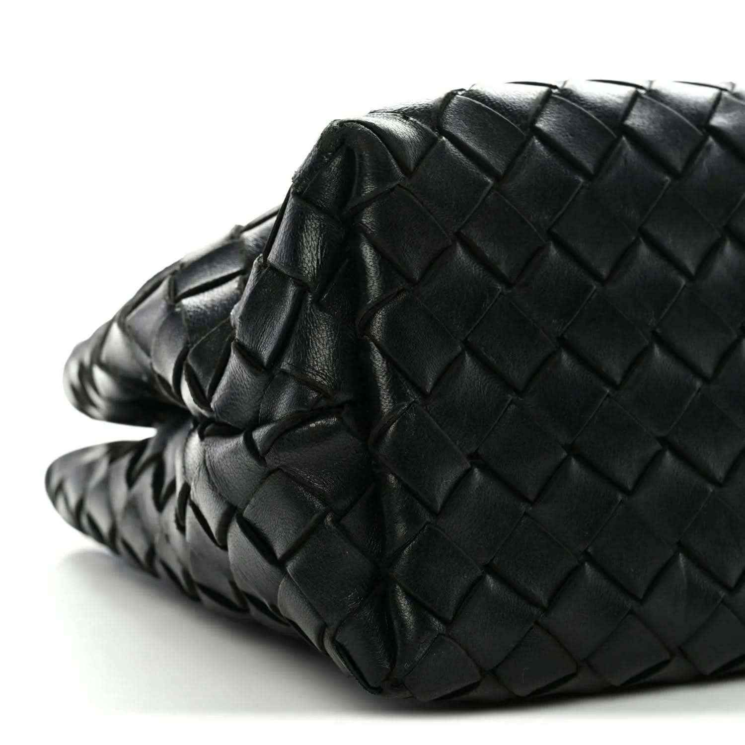 Black woven leather shoulder bag angled view with braided side strap