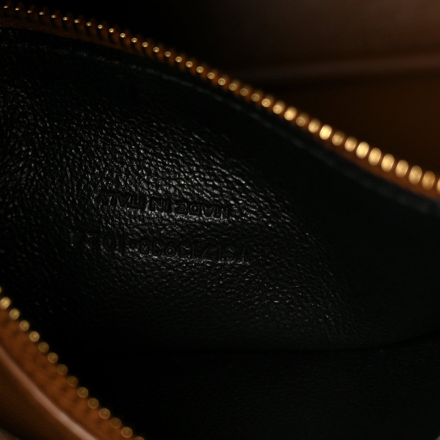 Saint Laurent hobo bag interior with gold-tone zipper pull and dark leather lining