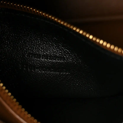 Saint Laurent hobo bag interior with gold-tone zipper pull and dark leather lining