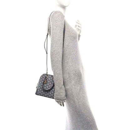 Grey coated canvas mini handbag with leather top handle, shown in side profile.