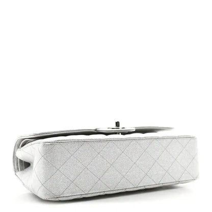 Chanel silver metallic double flap bag side view with quilted texture and top edge