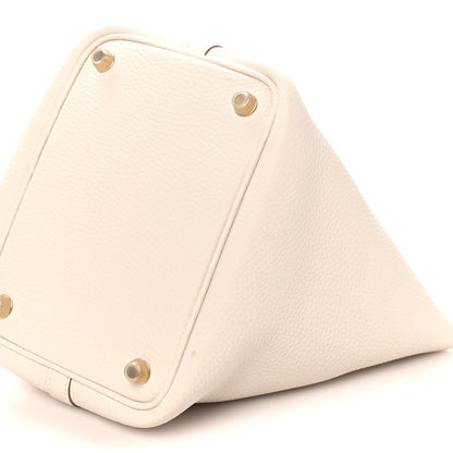 Pale cream leather tote corner base with metal rivets, close-up angled view