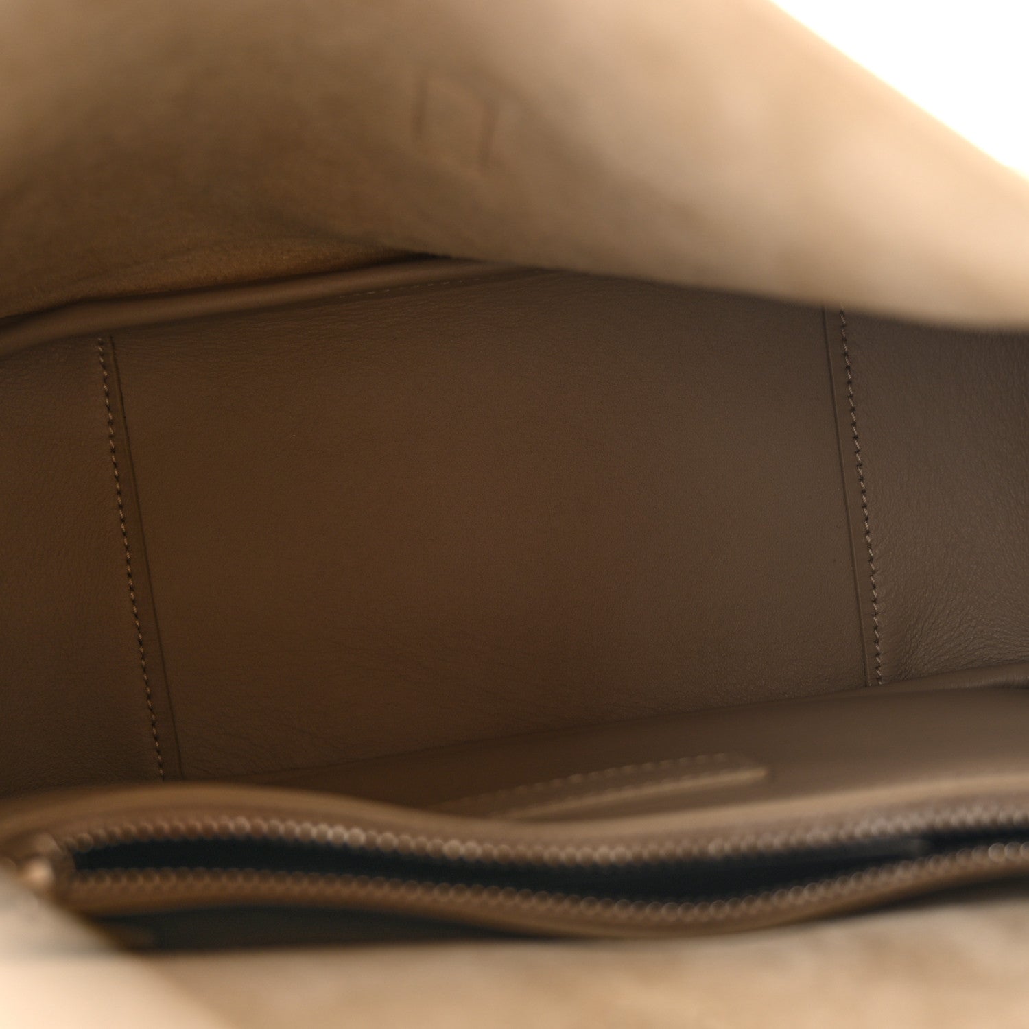 Small hobo bag interior with smooth beige lining and stitched edge