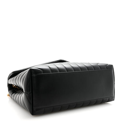 Black quilted calfskin satchel with structured bottom and snap-flap front