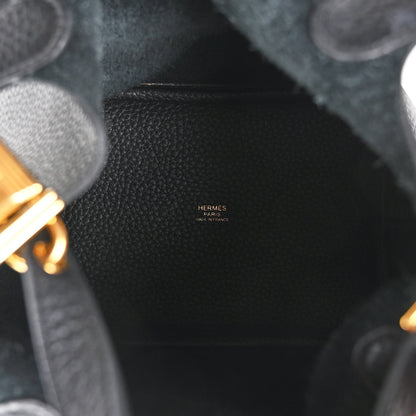 Black leather tote bag interior panel with stitched trim and small branding stamp