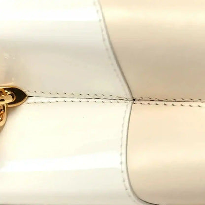 Louis Vuitton beige leather handbag front seam and curved top edge stitching