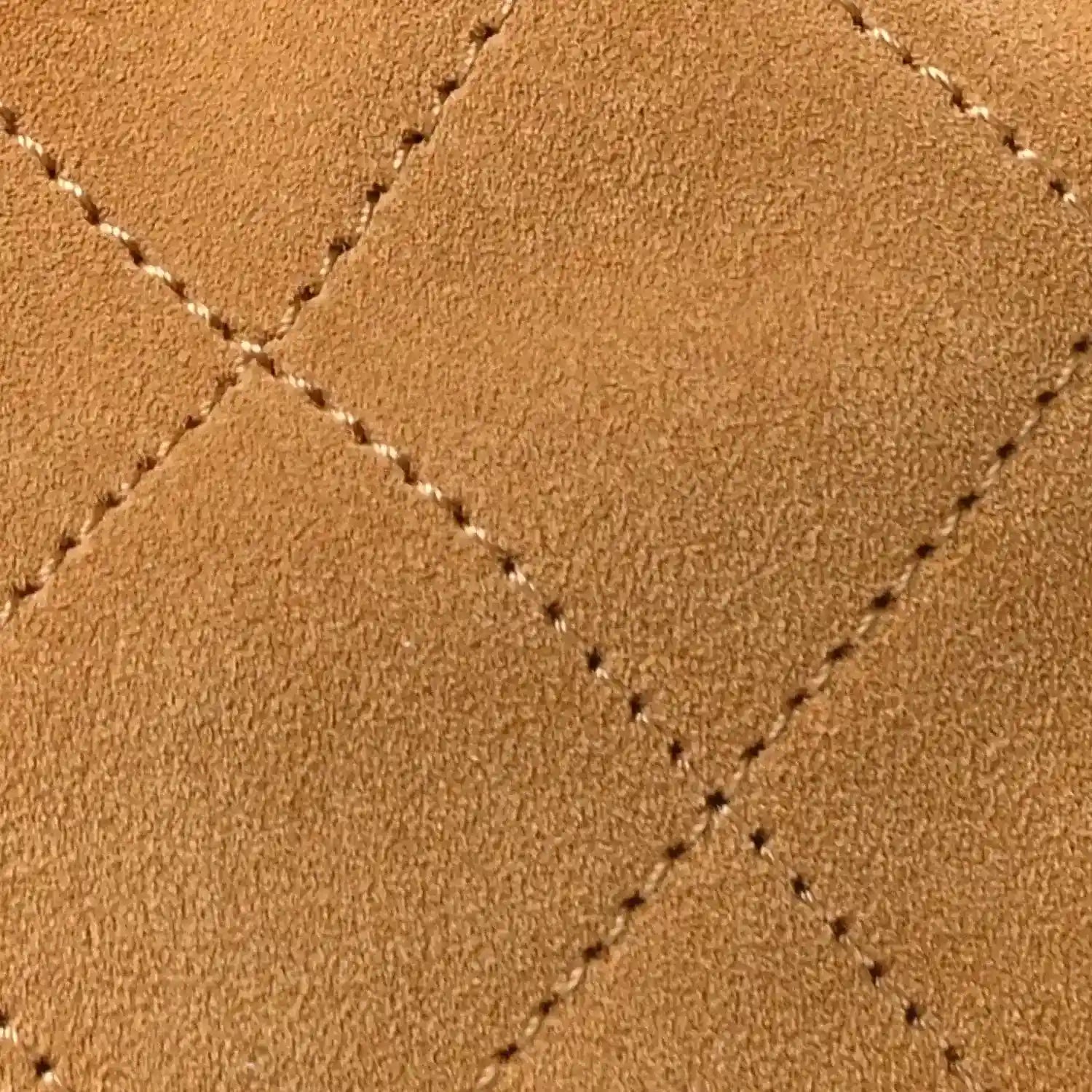 Chanel suede quilted surface with visible crosshatch stitching in classic beige