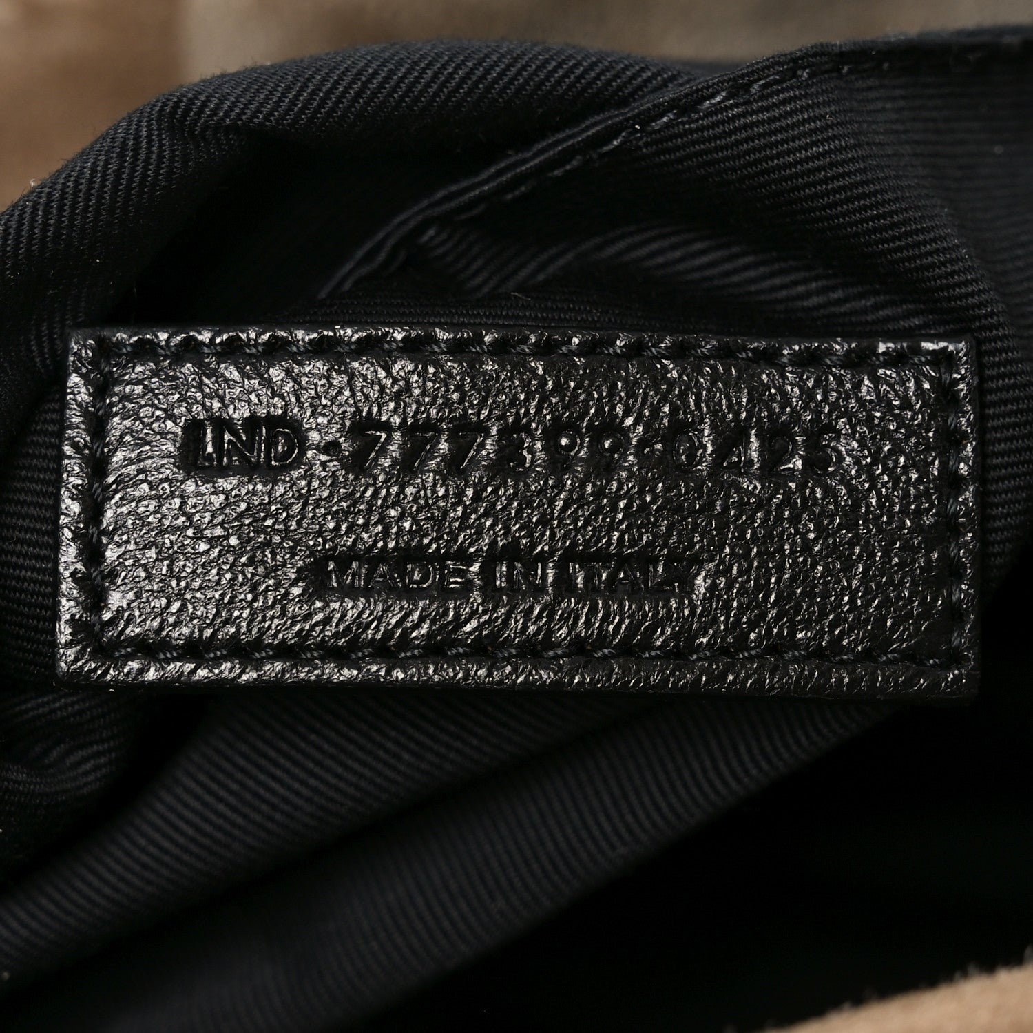 Saint Laurent Calypso bag interior label, black fabric tag with size text
