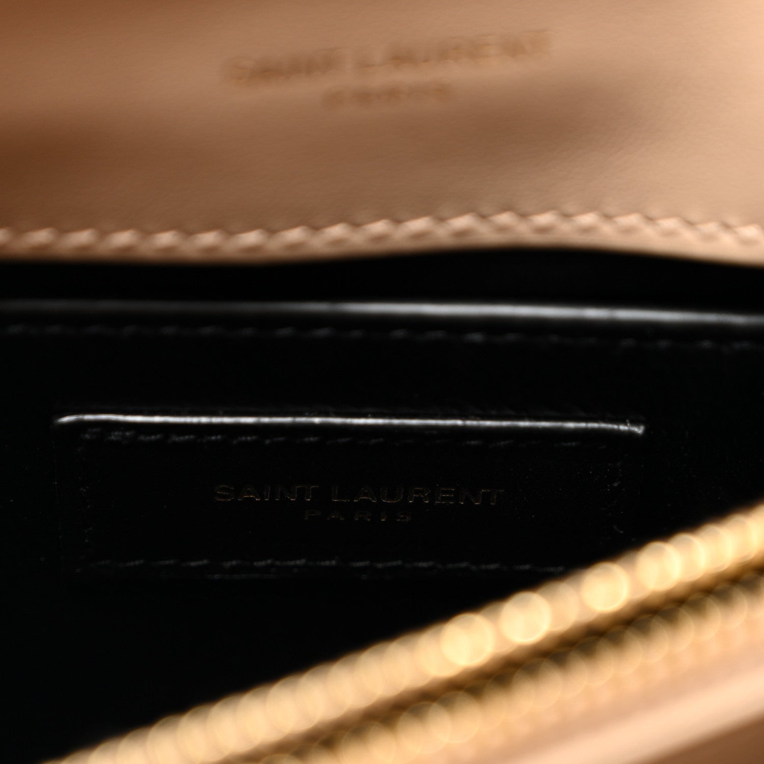 Inside leather label with embossed Saint Laurent text and dark trim