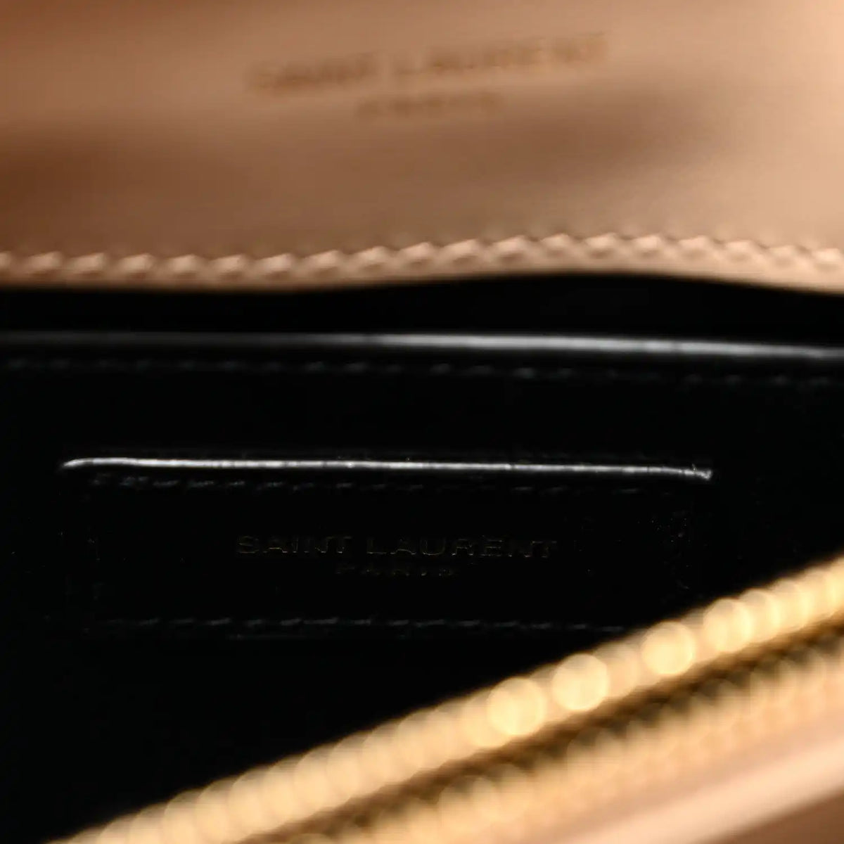 Inside leather label with embossed Saint Laurent text and dark trim