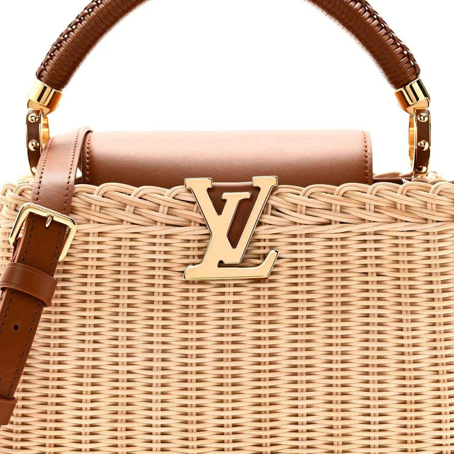 Tan rattan handbag close-up with gold LV emblem and brown leather top handle