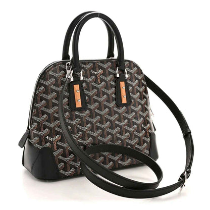 Mini handbag with monogram canvas, black top handles, and adjustable crossbody strap