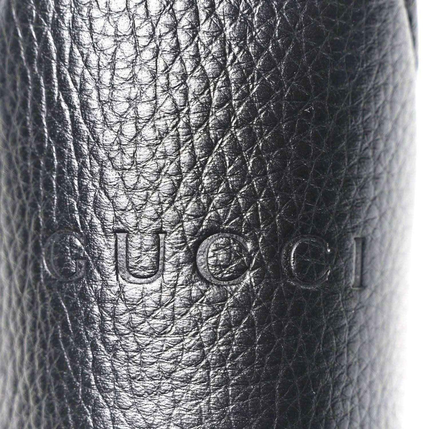 Black grained calfskin with embossed Gucci logo stamp