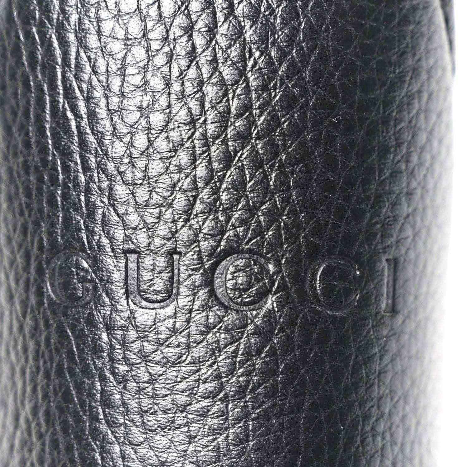 Black grained calfskin with embossed Gucci logo stamp
