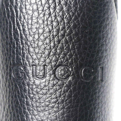 Black grained calfskin with embossed Gucci logo stamp